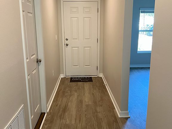 Entry and hallway. Garage door is on the left and front bedroom/bath are on the right.