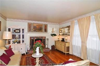 Living Room with Picture Windows, Wood Burning FP, and Hardwoods