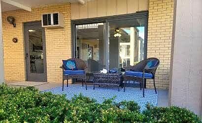 Ground floor patio surrounded by lush landscaping.