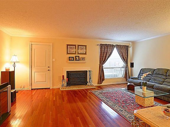 Large Family Room with Woodburning Fireplace, Crown Molding, Recent Back Door and AWESOME Brazilian Cherry Floors.
