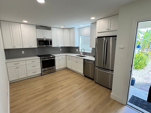 Newly remodeled kitchen with beautiful appliances, front entrance door,