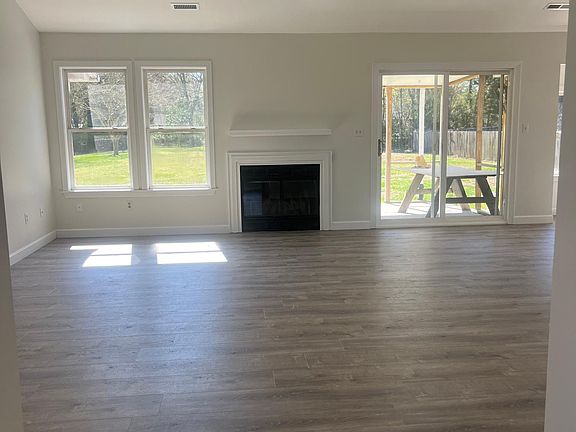 Great room with 6 foot, oversized ceiling fan & remote control (moves air very well). Real wood fireplace.