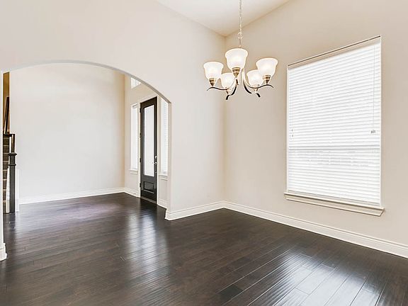 The formal dining room is located just off the kitchen, providing easy access for entertaining.