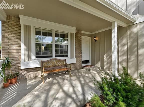 Relax on this front covered porch