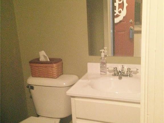 Convenient half bath, just steps away from the family room. (You can see the front door in the mirror.)