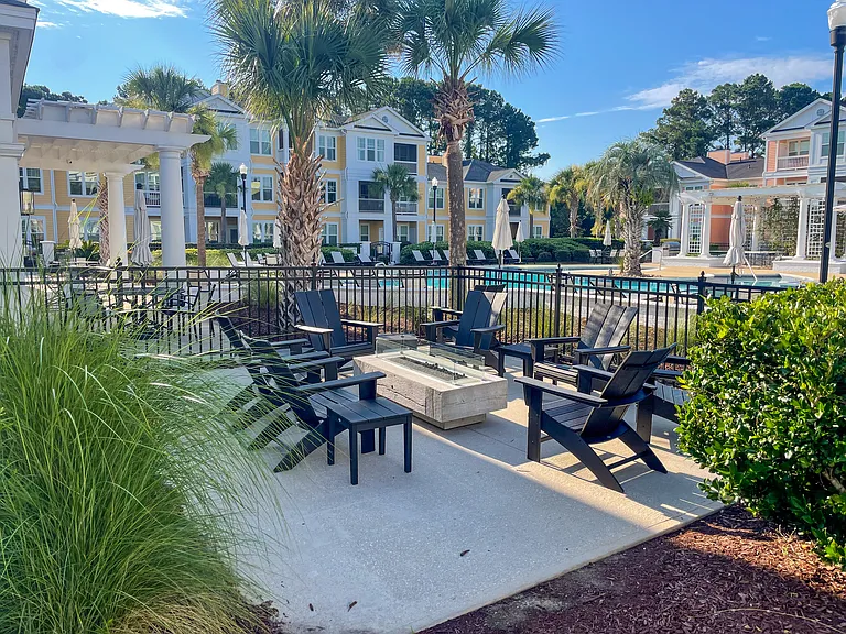 Community gas fire pit next to the pool