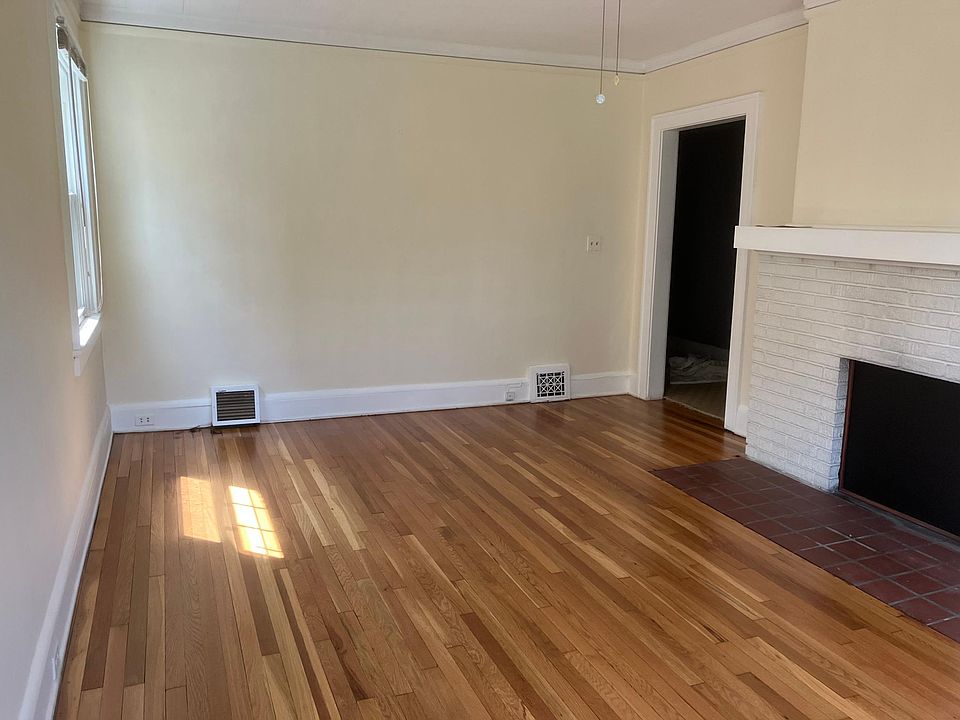 Living room: new hardwood floor, decorative fireplace, ceiling fan, modern insulating windows.