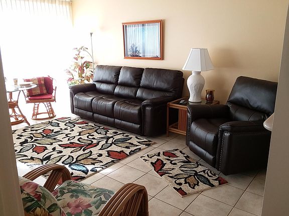 New leather reclining sofa and chair. Tiled floors. Accent carpets.