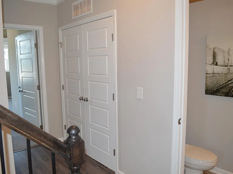 Next to the powder room is the laundry closet (laundry machines are provided), followed by the master bedroom.