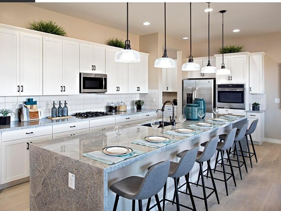 Gourmet kitchen with waterfall 15 feet island. Gas stovetop. Stainless steel appliances. Large farmhouse sink. Beautiful wood flooring. Pendant lighting