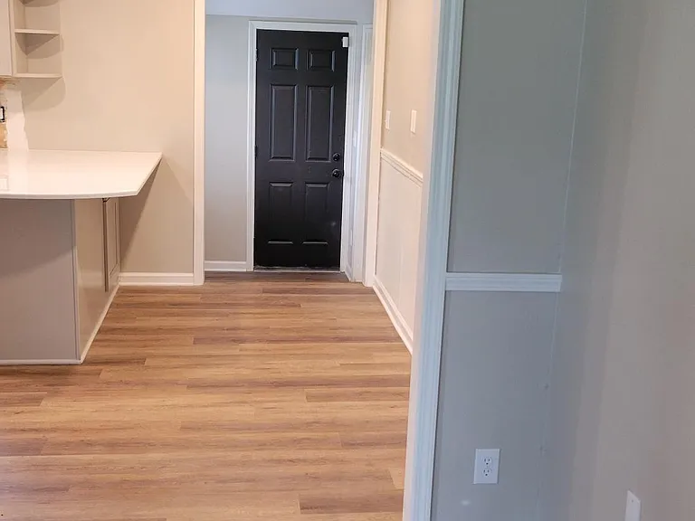 View from living room into kitchen and backdoor
