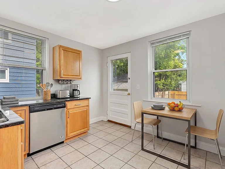 This is a staged photo with furniture, but there is room for a small table in the kitchen.