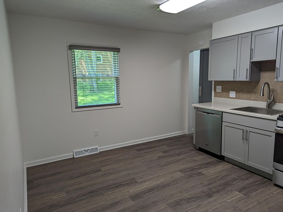 Plenty of room for kitchen table and chairs, entrance to basement stairwell has sliding barn door