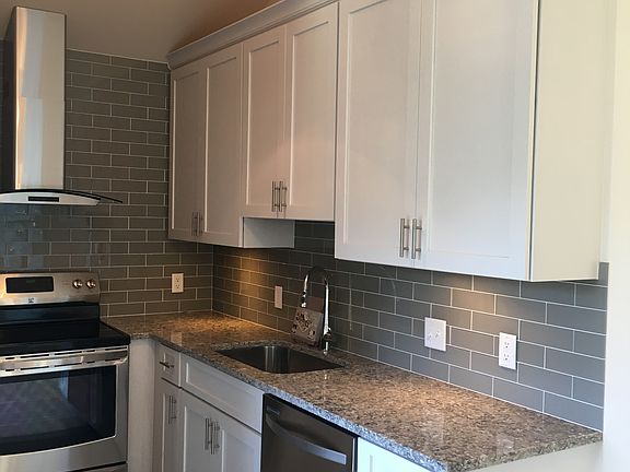 kitchen with stainless appliances & quartz countertops