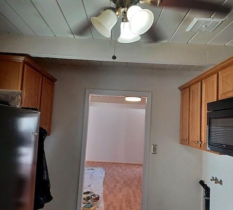 Galley kitchen with washer/dryer on each side