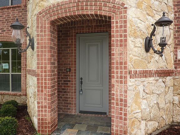 Elegant entry has large light fixtures