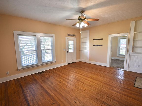 Large family room with built-in bookcases & original hardwoods from 1910!
