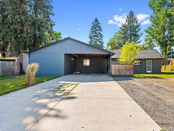 Alley view- Driveway with Ample covered parking or flexible outdoor space- ideal for your car, bikes or extra storage. Also the rear entrance.