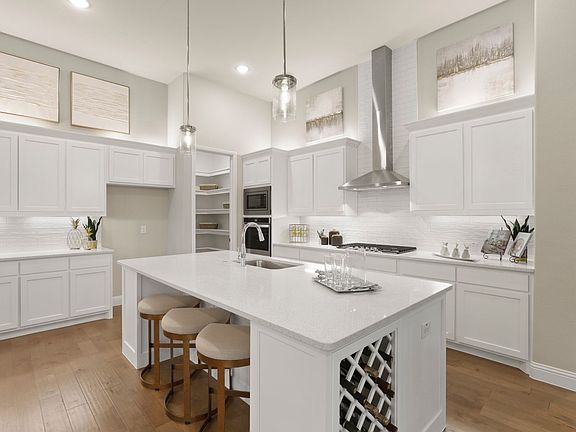 REPRESENTATIVE PHOTO - Kitchen in the Rapport home plan by Trophy Signature Homes