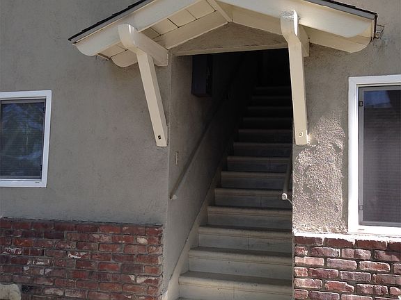Stairs on side of building leading up to unit
