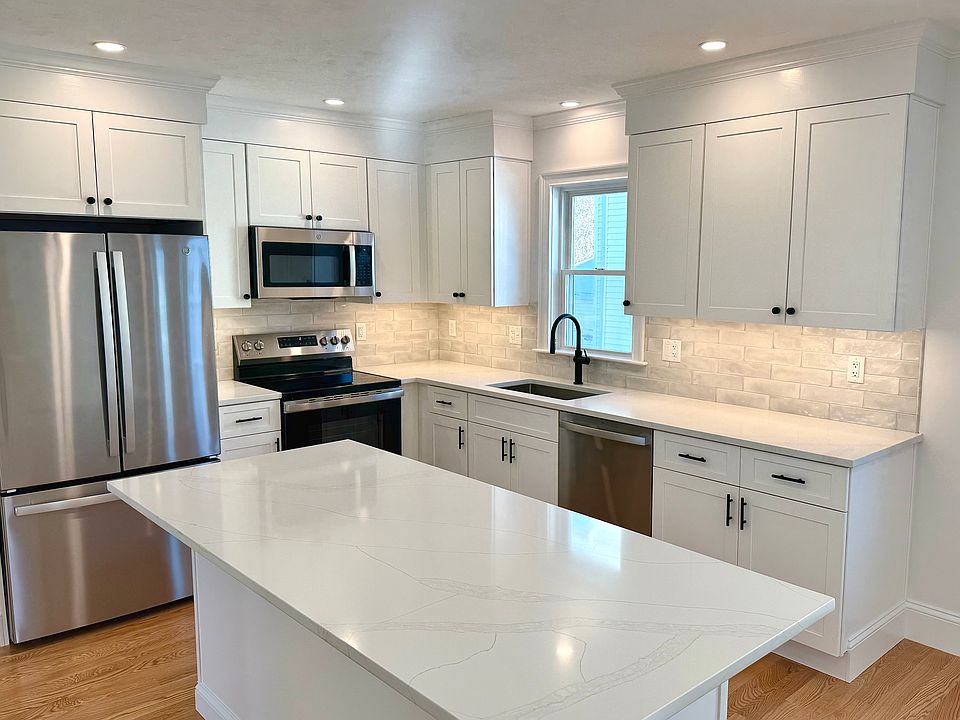 Kitchen: Brand New Stainless Steel Appliances, Quartz Countertops with Open Layout into Living Area