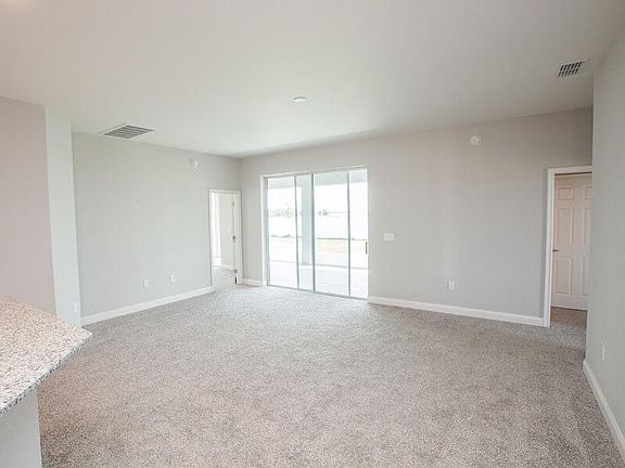 Sunny, open gathering room - New home for sale in Auburndale, FL