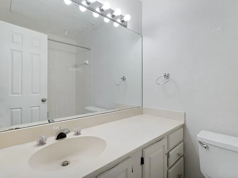 Guest Bathroom. Vanity with a single basin, a chrome faucet, and ample counter space