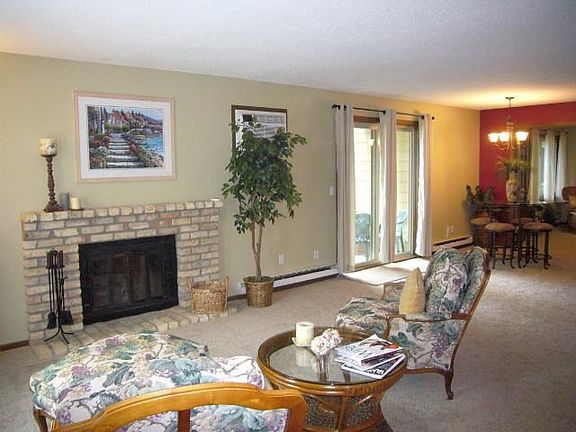 Beautiful wood-burning fireplace anchors the roomy and light-filled living room.