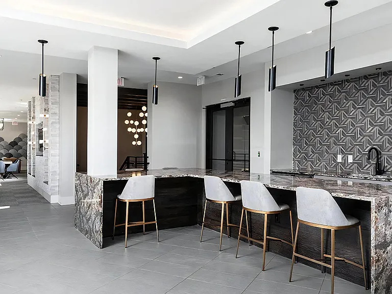 Multi-Use Community Lounge with Game Tables and Bar Area