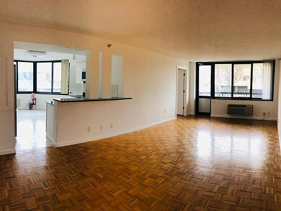Living room and dining room, view of balcony and open kitchen