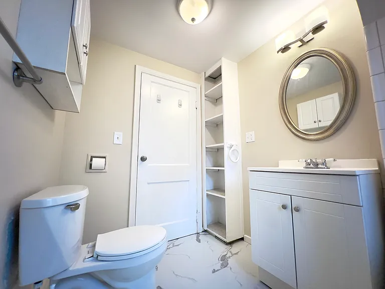 Spacious bathroom with extra storage and 2 light fixtures