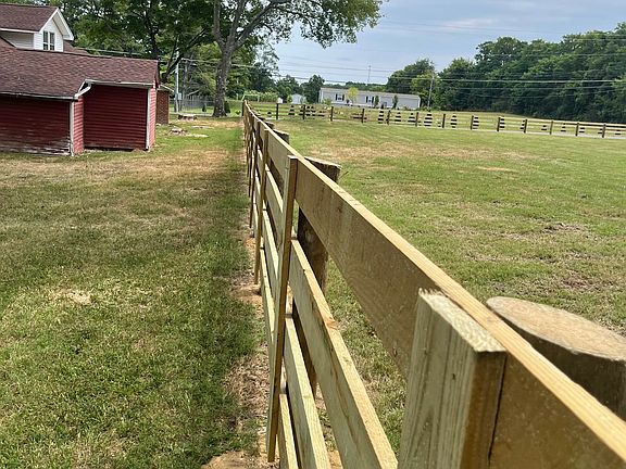 new board fence along the southen boundary - open land on both sides of the property
