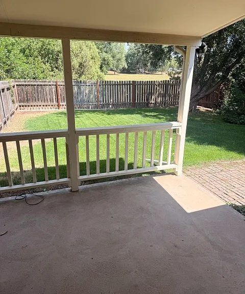 from kitchen to covered patio and rear fenced yard, backs to open space.