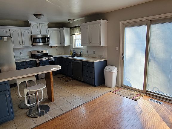 Open Kitchen Diningroom room concept. 
New gas stove, dishwasher, microwave and refrigerator. Sliding patio door leads to outside cement patio.