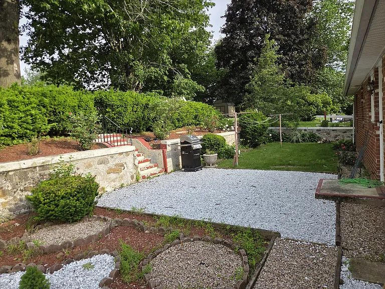 Nice back patio with more landscaping followed by the stairs.