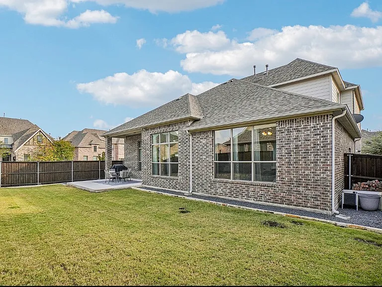 Rear of home with a large patio and yard. Fully landscaped and sprinklers