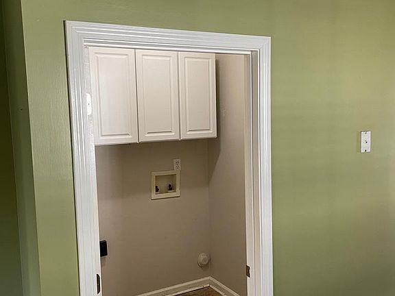 Large laundry with built in cabinets.