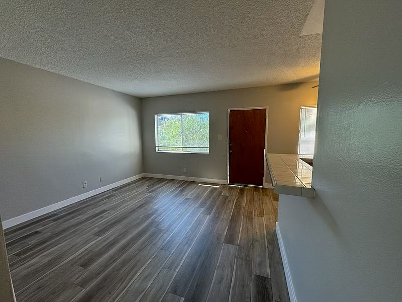 living room and entrance with new vinyl plank floors and new paint