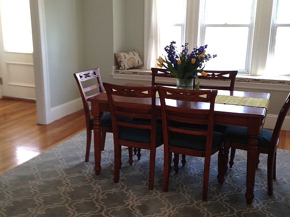 The 12 x 14 dining room has a built-in window seat looking t