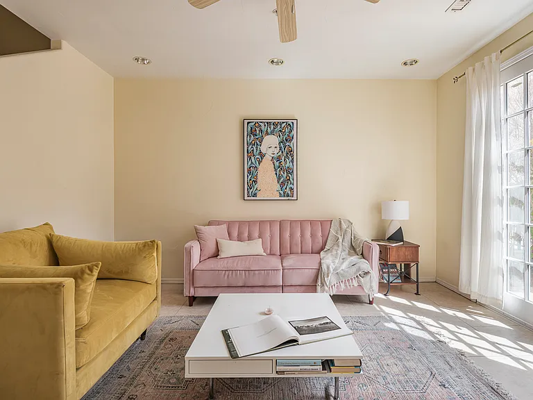 First-floor living area with adjacent full bathroom, offering flexible use as a guest suite or additional living space.