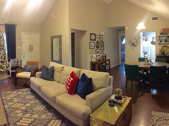 Cathedral ceiling and hardwood floors in living room and din