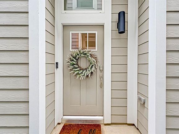 A quiet side entrance that opens up to an inviting entry way.
