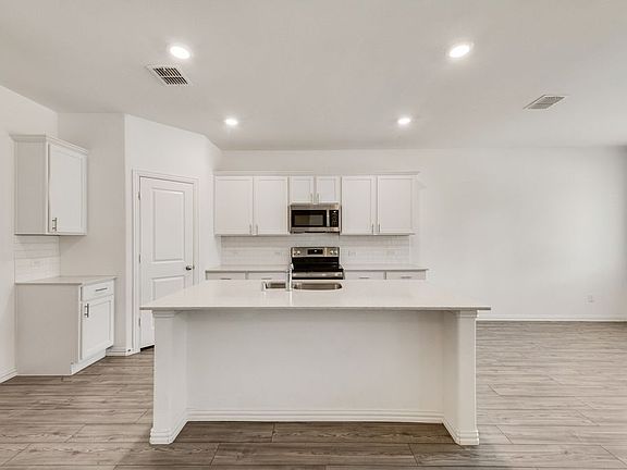 Kitchen featuring a large island with breakfast bar.