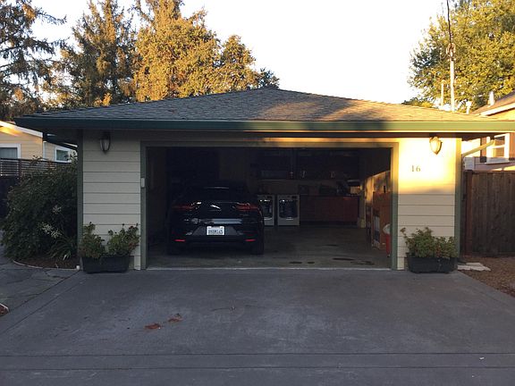 View with SUV parked inside garage.