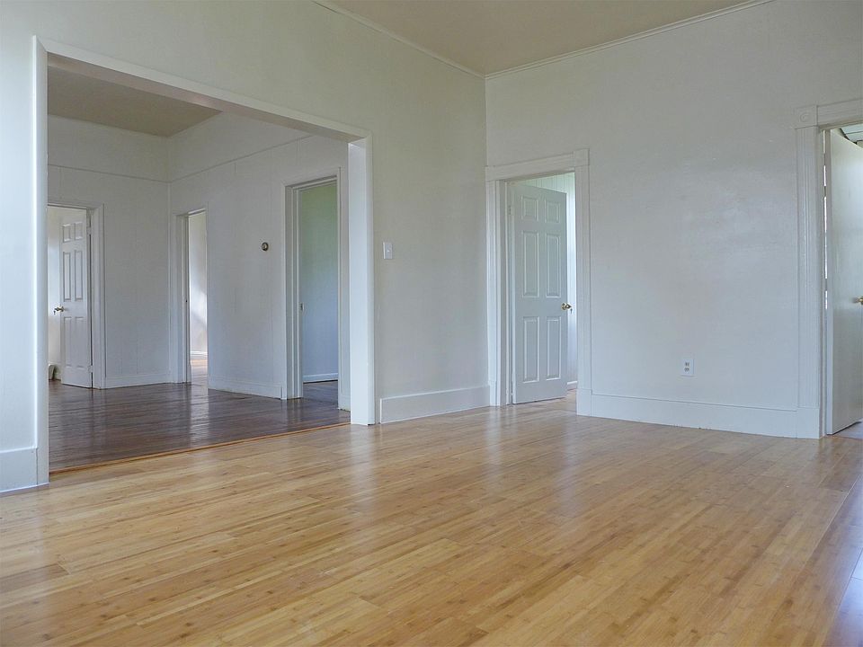 Dining room w/ new bamboo floor, living room w/ original hardwood