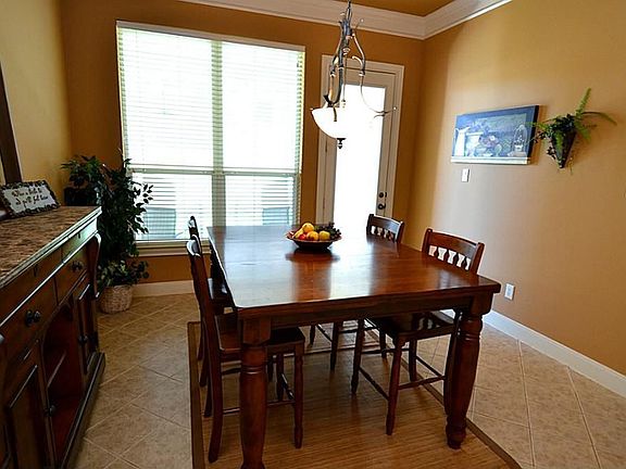Next to the kitchen is a huge breakfast area with a door to a small patio and the backyard.