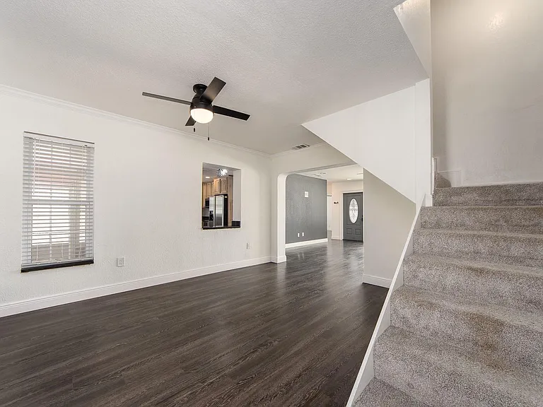 Family Room with staircase leading to 3rd bedroom.