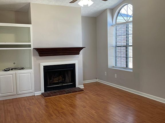 Spacious open-concept great room with wood burning fireplace complete with mantle. Cathedral ceiling, lots of natural light.