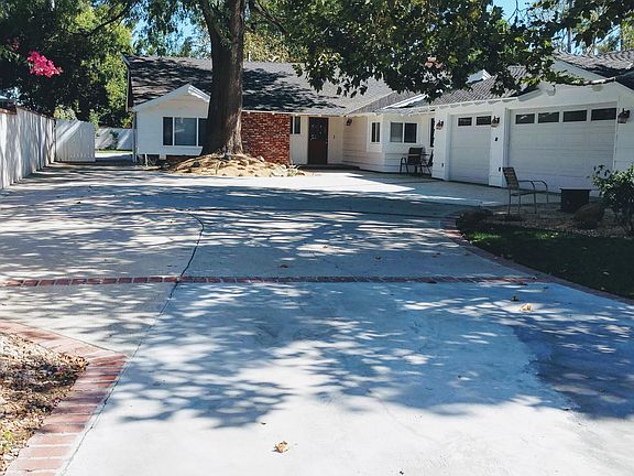 Large gated and fenced front yard. Perfect for kids. 3 car finished garage with remote controlled doors