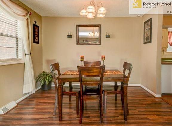The dining area also has laminate flooring and is open to the fa